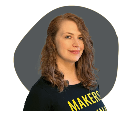 headshot-of-michelle-tanco-on-a-dark-grey-organic-grey-shape