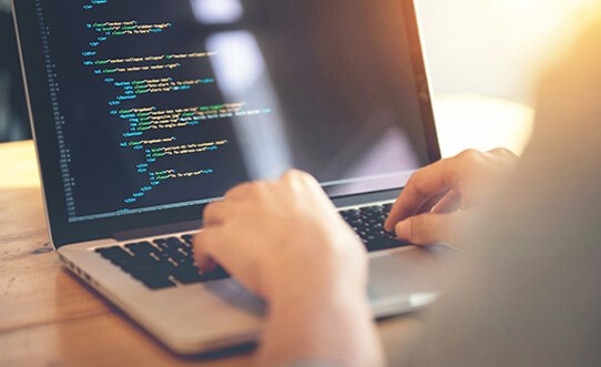 image-of-laptop-and-person-typing-code