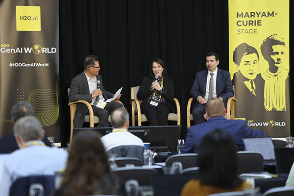 Two panelists talking to Dr. Agus Sudjianto