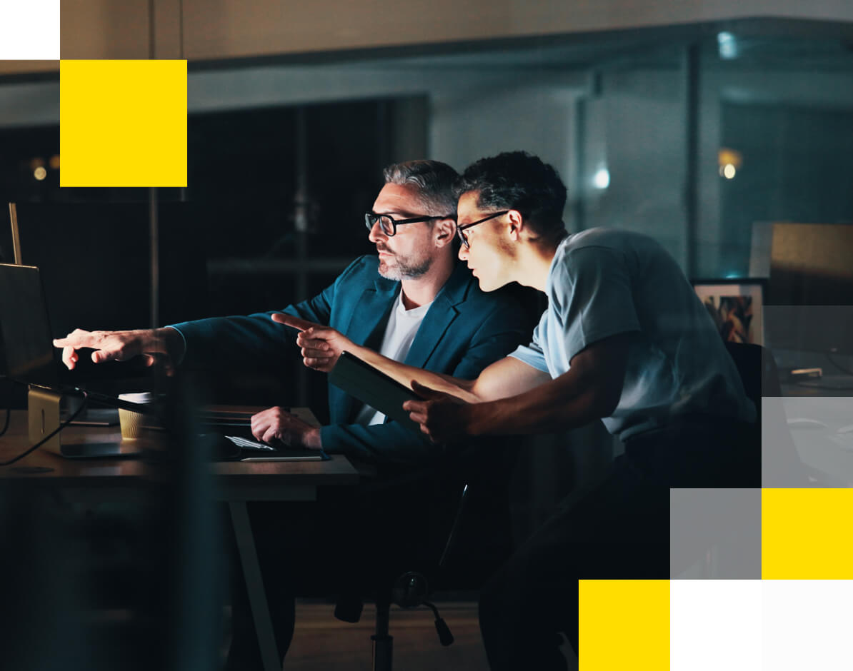 2 business analysts looking at content on 6 screens